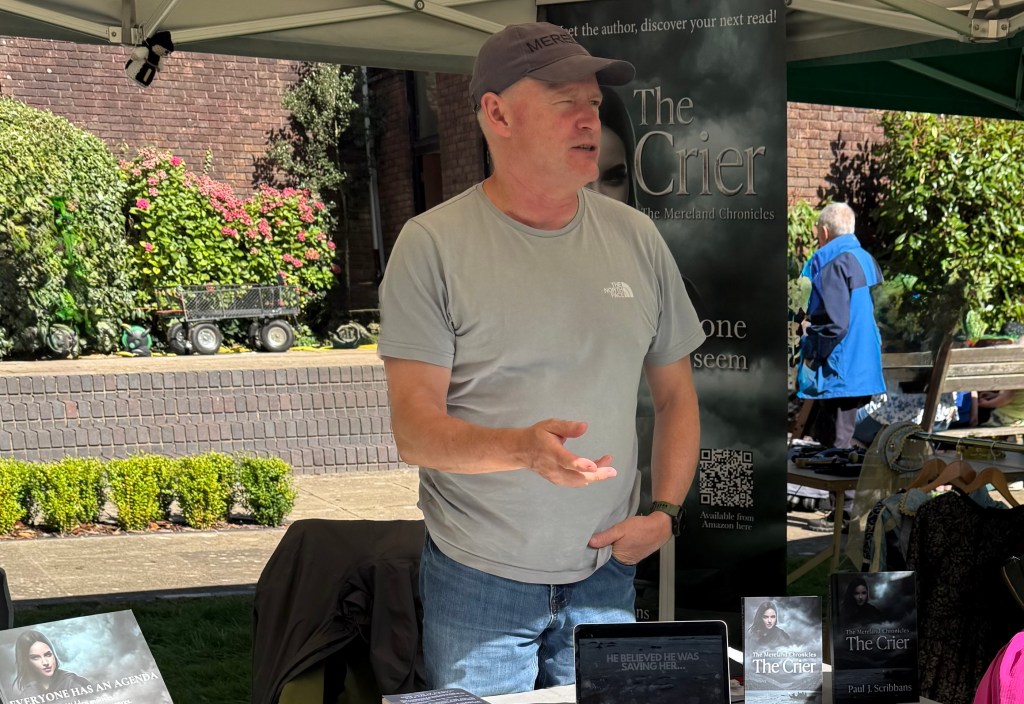 Author Paul J. Scribbans at a sell-out book fair with copies of The Crier on display